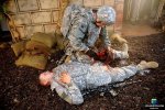 Combat Medic tends to Soldier Injured in combat trauma scenario